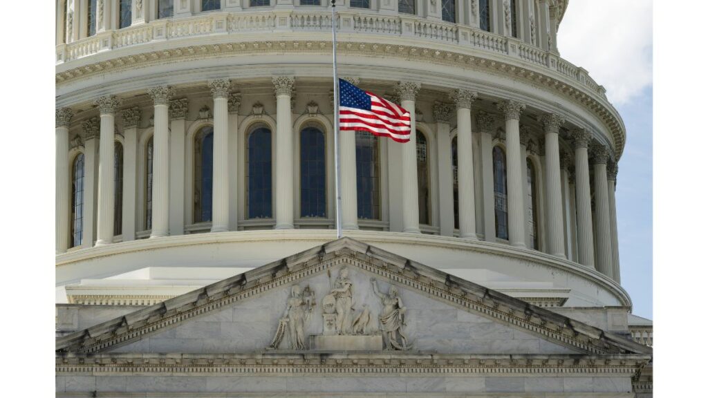 United States Capitol building with an American flag flying in front